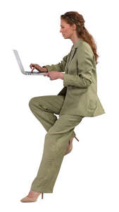 woman sitting and working with laptop