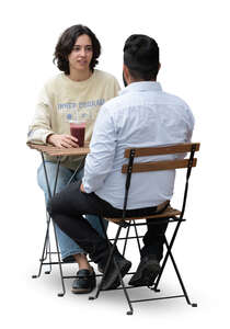 man and woman sitting in a street cafe