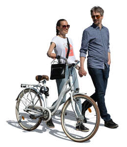 couple with bicycle walking