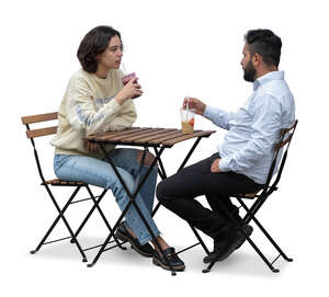 man and woman sitting in a street cafe and talking