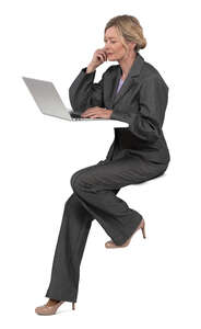 woman sitting at a counter table and working with laptop