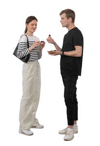 woman and man standing and eating cherries
