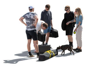 group of people with bags and a dog