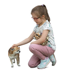 little girl petting a small dog