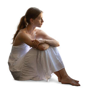 backlit woman in a white dress sitting by the window