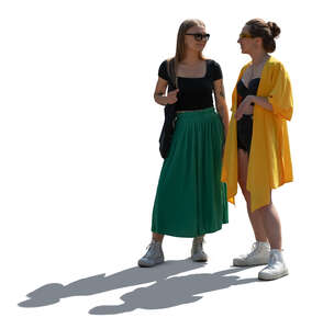 two backlit women standing and talking