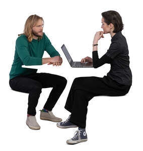 man and woman sitting by the table and working with computer