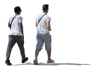 two sidelit men walking