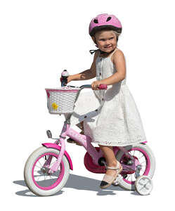 little girl in a white dress riding a bike