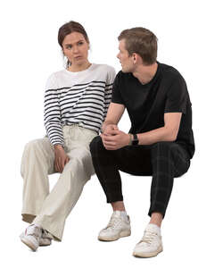 man and woman sitting and talking