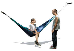 woman sitting in a hammock under a tree and talking to a guy