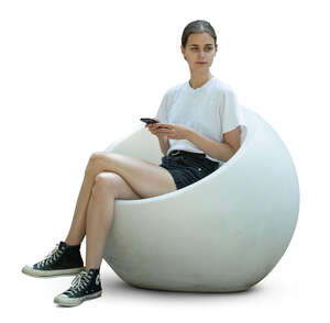woman sitting in a ball shaped chair