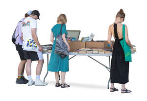 people standing by the book stand and looking at books