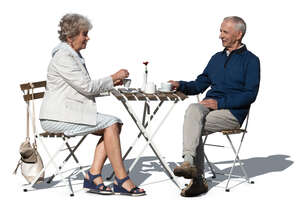 elderly couple sitting in an outdoor cafe