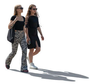 two young backlit women walking