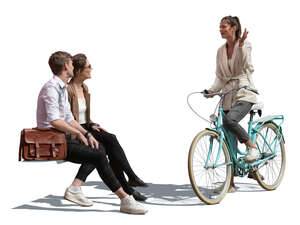 woman with a bike talking to two friends sitting