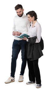 man and woman standing and reading a book