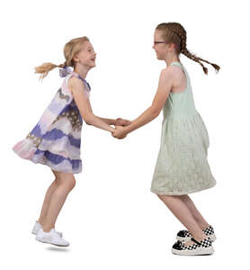 two girls holding hands and dancing