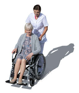 nurse pushing a woman in a wheel chair seen from above