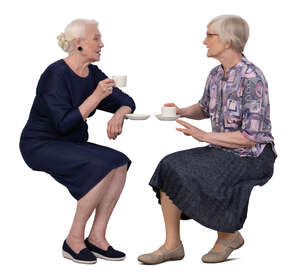 two older ladies sitting and drinking coffee