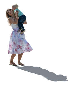 backlit woman lifting up her son