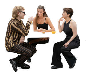 group of three people sitting and talking in a coffeeshop