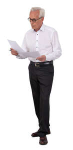 older businessman standing and reading some papers