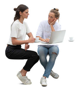 two women with laptop sitting and drinking coffee