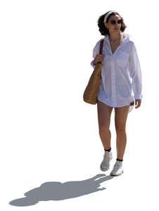 backlit woman in summer walking