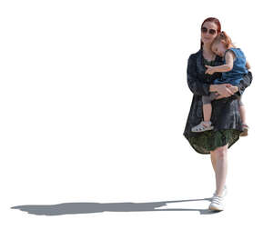 sidelit woman carrying her daughter walking