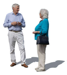 two grey haired people standing and talking