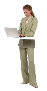 woman standing by a desk and working with a computer