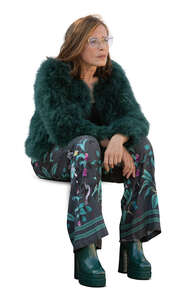 woman in a green furry jacket sitting