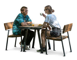 man and woman sitting in a partial shade and drinking coffee