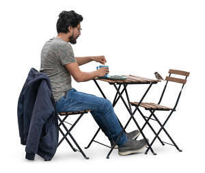 man sitting in a cafe and drinking coffee