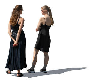 two women wearing black dresses standing