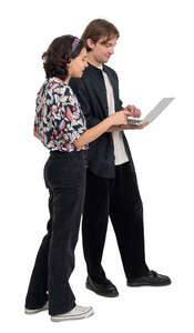 young man and woman standing and looking smth from a laptop