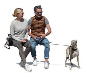 man and woman with a dog sitting and talking