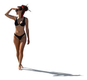backlit woman in bikini standing and looking at smth
