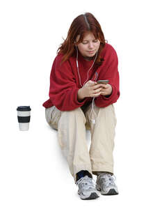 woman sitting and listening to music and drinking coffee