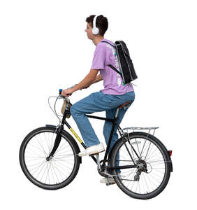 teenage boy with headphones and backpack riding a bike