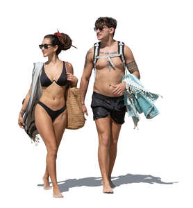 man and woman in bathing suits walking on the beach