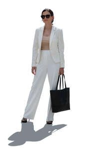 backlit woman in a white suit standing