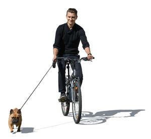 man riding a bike with a dog running beside him