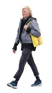 man with a yellow canvas bag walking