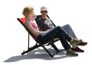 two people sitting in garden chairs