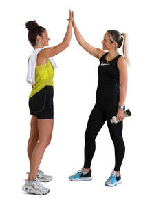 two cut out women in gym greeting each other with high five