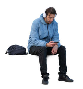 man in a blue jacket sitting