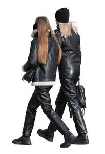 two women dressed in black leather walking