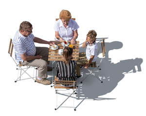 top view of grandparents sitting in a cafe with their grandkids